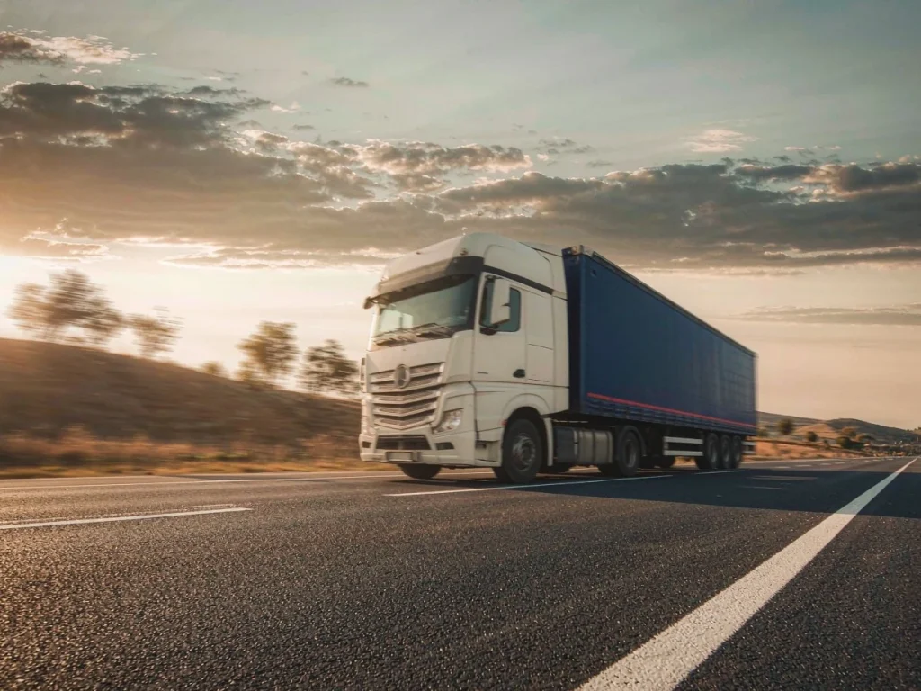 A container truck on the highway at sunset