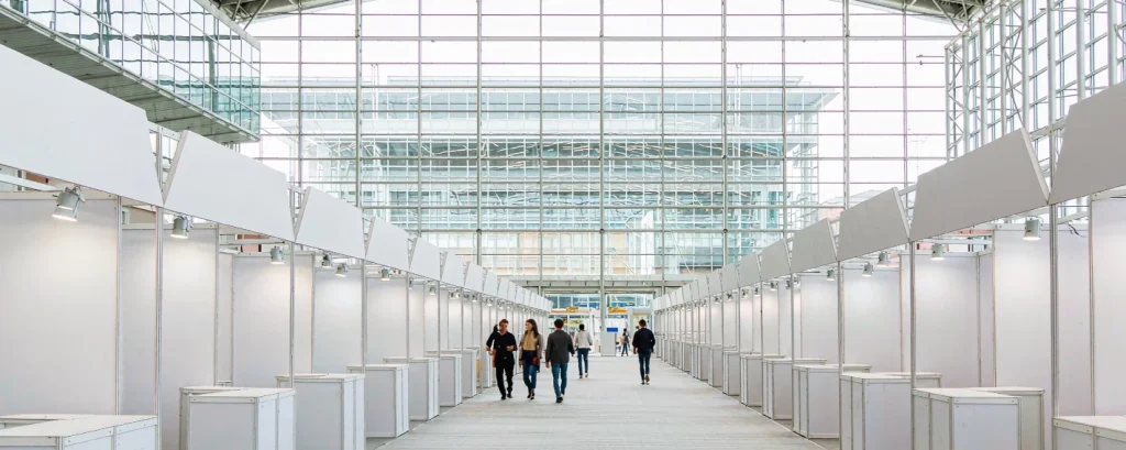 Visitors walking through a modern international trade fair hall