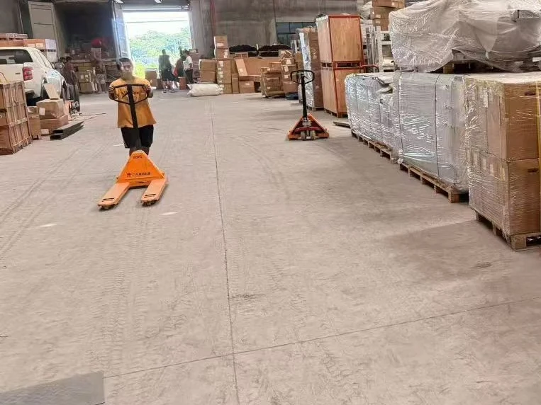 Pallets of cartons being moved along a warehouse aisle